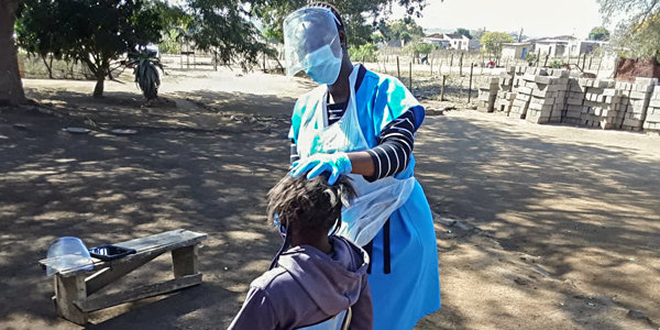 Wits Agincourt nurse Olivia Khosa tests a child in rural Bushbuckridge for COVID for the PHIRST study